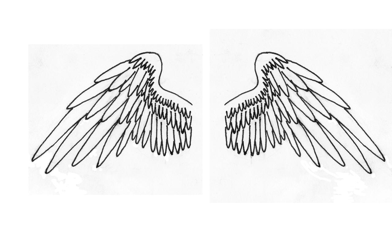 angel wings with letter tattoo